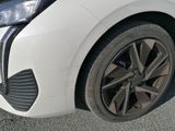 a close up of a white car with black rims