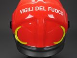 a close up of a red fire helmet on a black surface