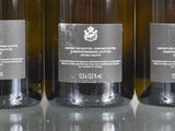 three bottles of wine that are sitting on a table