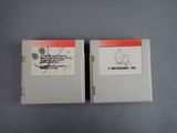 two nintendo game cartridges sitting next to each other on a table