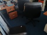 a desk with a chair and a computer on it