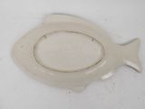 a white plate with a fish shaped design on it