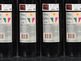 six bottles of wine are lined up in a row on a table
