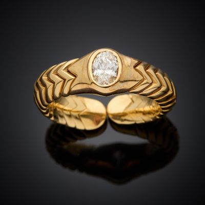 a close up of a gold ring with a diamond in the center
