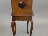 pair of antique wooden chairs with a hole in the back