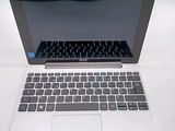 an open laptop computer sitting on top of a white table