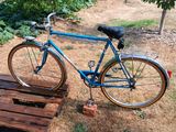 a blue bike that is parked on a wooden pallet