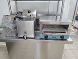 a silver counter top with a toaster and a basket on it
