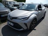 the toyota c - hr is parked in a parking lot with other cars