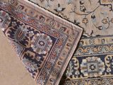 two rugs on the floor with different colors and patterns