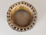 a picture of a gold and black ring on a white surface