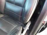 a close up of a car seat with a broken arm rest