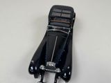 a black toy car that is sitting on a table