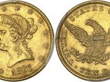 une pièce d'or représentant un aigle au recto et une femme au verso