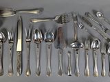 a lot of silverware on the table with spoons and spoons