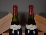 two bottles of wine sitting next to each other on a table