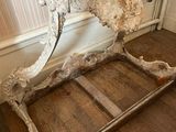 an old wooden bed frame in a bathroom with a sink