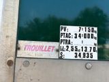 a sign on the door of a building that says trouillet