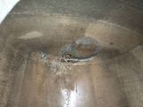 a large metal pot with a hole in it