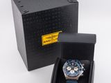 a black box with a watch inside of it on a white surface