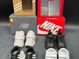several pairs of shoes and a shoe box on a table