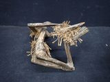 a wooden sculpture of a person sitting on a chair