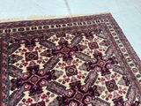 an image of a rug on a tile floor with a cat laying on it
