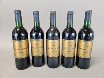 quatre bouteilles de vin sont alignées sur une table