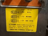 a machine that is sitting in a room with a yellow label on it