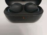 a pair of black earphones sitting in a case on a table