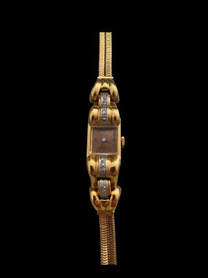 an image of a close up of a gold watch on a black background