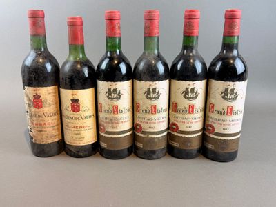 six bottles of wine are lined up in a row on a table