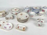 many different types of dishes and cups on the table