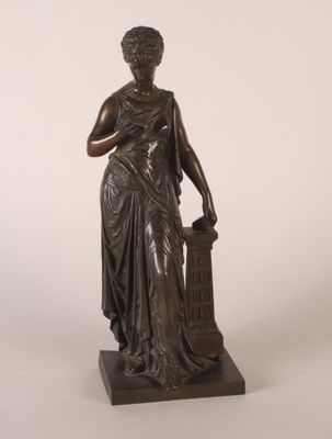 une statue en bronze représentant une femme tenant un vase