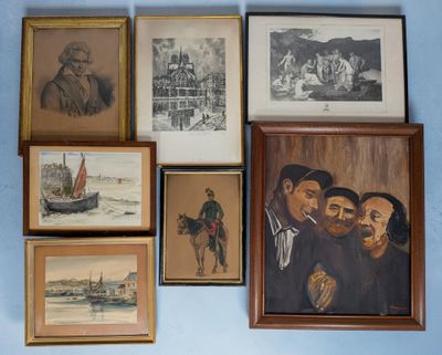 many framed pictures on the wall of this room