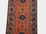 a long red and blue rug with a pattern on it