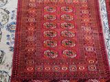 two rugs are laid out on a bed with a cat sleeping on the bed