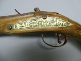 a close up of a rifle with a brass plate on it