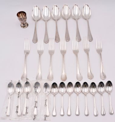 a lot of silver spoons and forks on the table