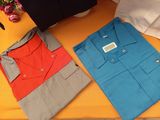 two shirts that are sitting on a table next to each other