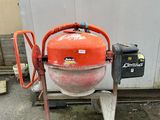 an orange machine that is sitting on the ground