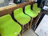 several green chairs are lined up in a row in a room