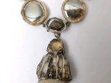 a necklace that has a picture of a woman on it