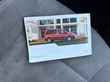 a picture of a picture of a red van on the seat of a car
