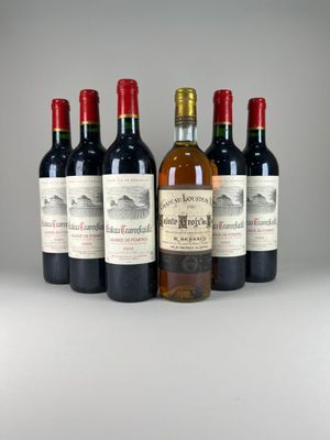 six bottles of wine are lined up in a row on a table