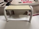 a small table with a sign on it in a store