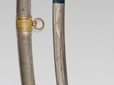 pair of silver and gold - plated swords with blue and gold decoration