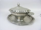 an antique silver plate with a saucer and tray on a white surface