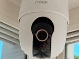 a white camera mounted on the side of a window