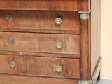 a wooden chest of drawers with a marble top